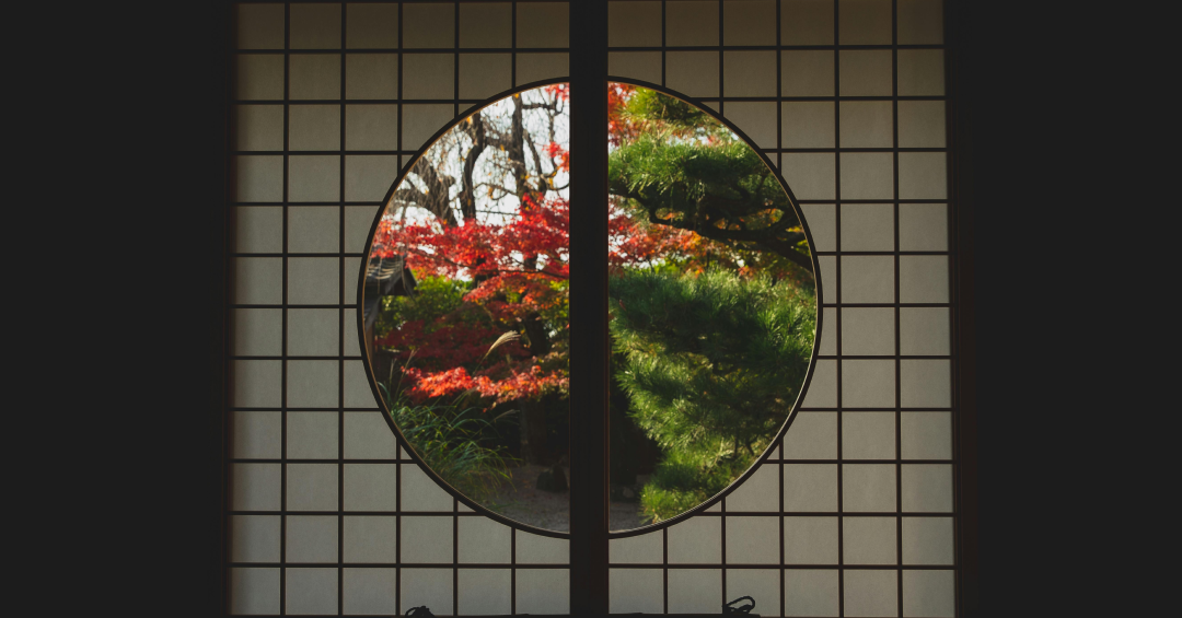 Window in Japanese style with view of trees in autumn