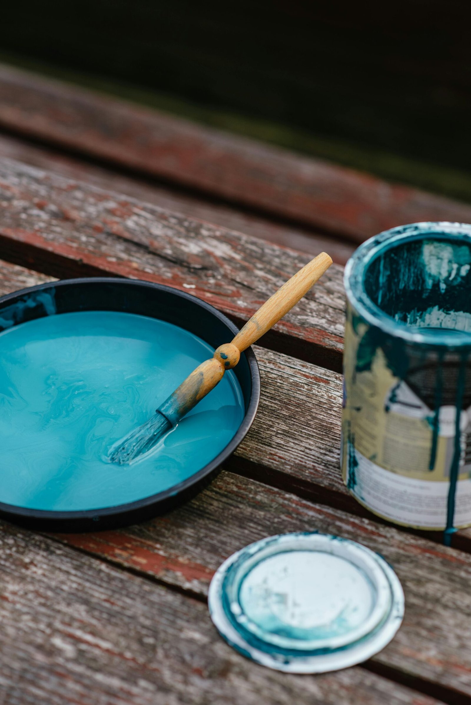 Bowl of paint near jar on bench