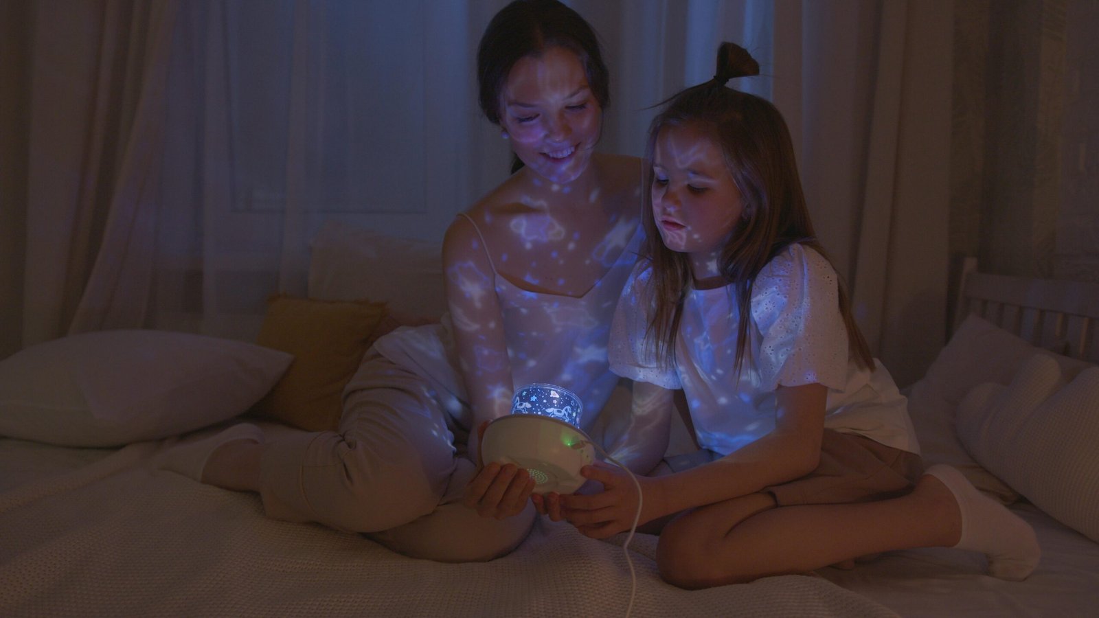 Photo of a Woman and Her Daughter Looking at a Lamp