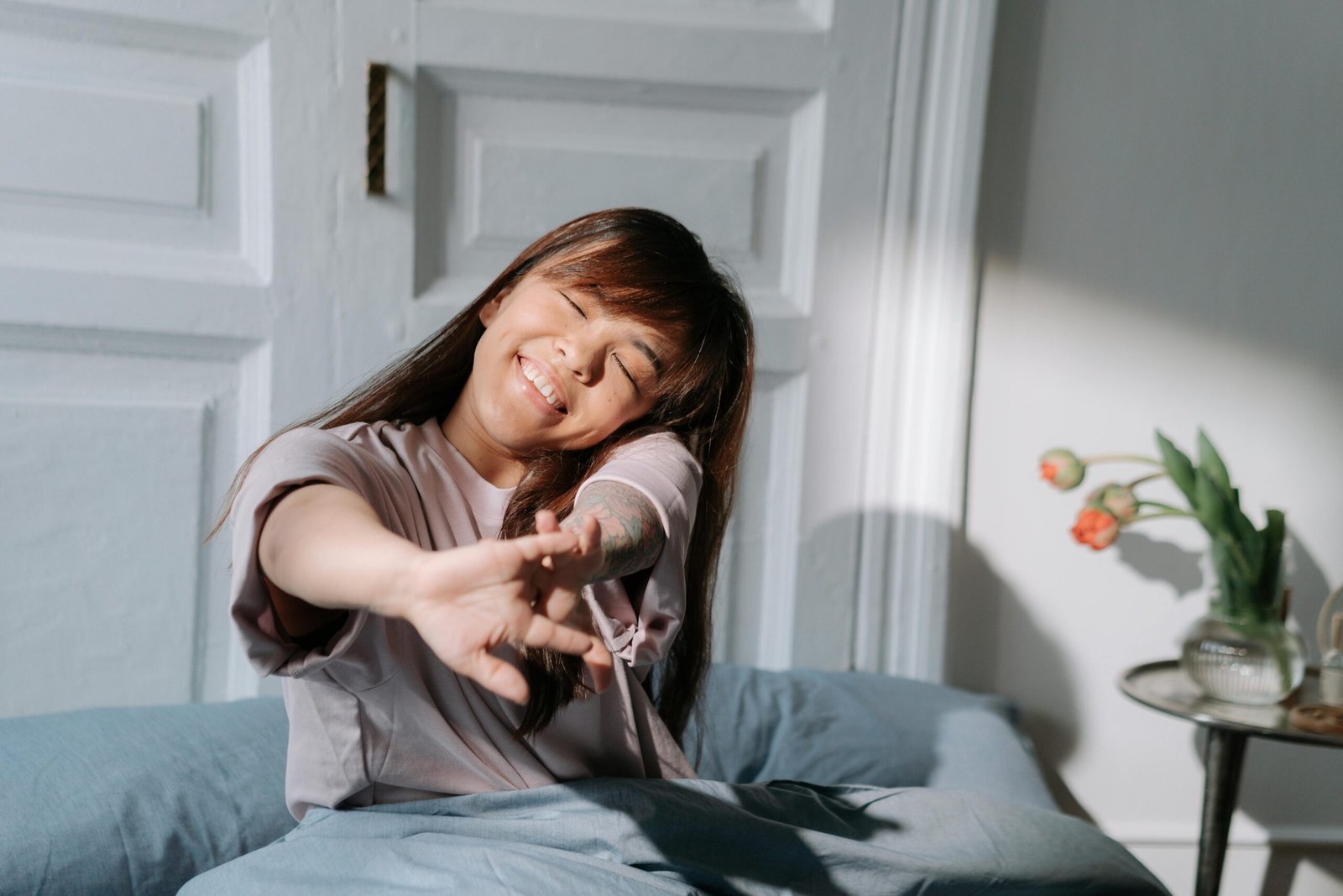 Woman with dwarfism stretching while waking up